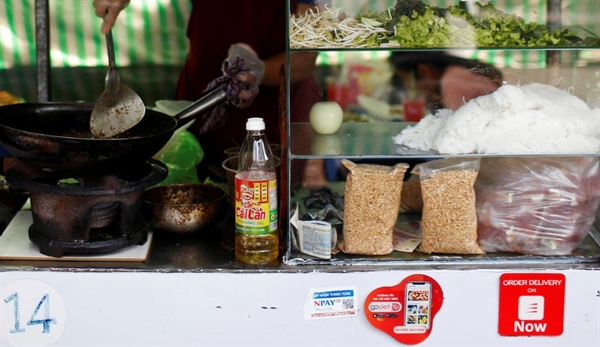 Mobile e-payment logos are seen at a street food stall in Ho Chi Minh City. Photo: Reuters/Yen Duong
