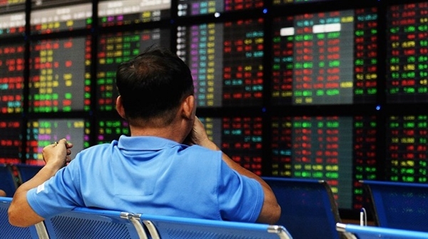 An investor monitors share prices on an electronic board at a local securities trading floor in Hanoi. Photo by AFP