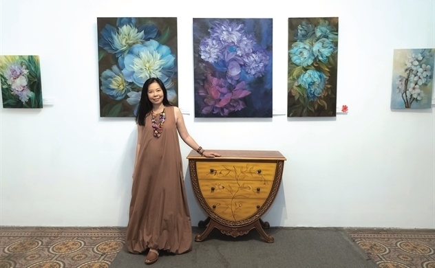 Female artist paints flowers in mindfulness